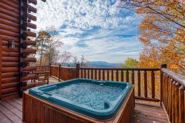 Hot tub on a deck with a mountain view at The Original American Dream, a 2 bedroom cabin rental located in Gatlinburg