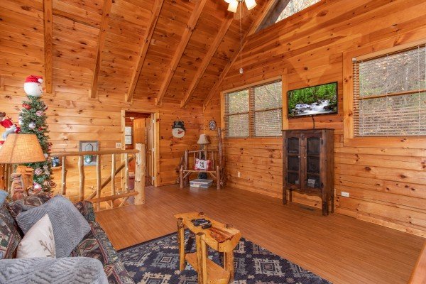 Seating area with television in the loft at The Original American Dream, a 2 bedroom cabin rental located in Gatlinburg