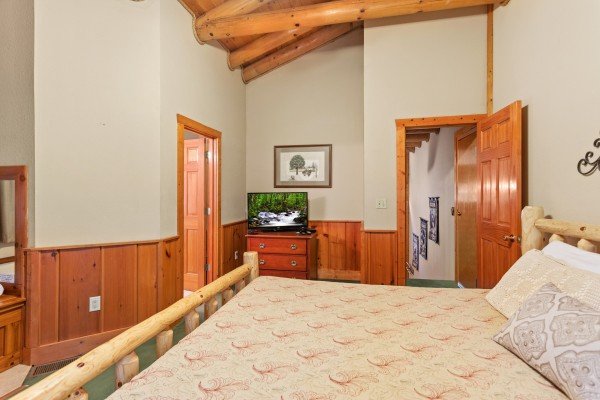 Bedroom with a log bed, dresser, and TV at Starry Starry Night #725, a 2 bedroom cabin rental located in Pigeon Forge