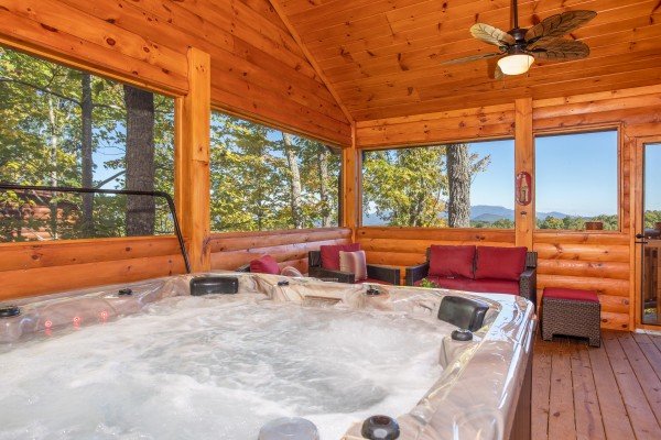 Hot tub on a screened in porch at Panorama, a 2 bedroom cabin rental located in Pigeon Forge