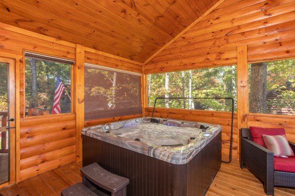 Hot tub on a screened in porch at Panorama, a 2 bedroom cabin rental located in Pigeon Forge