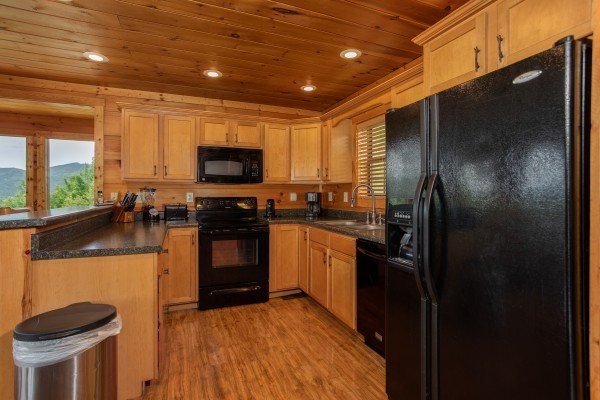 Kitchen with black appliances at Mountain Bliss, a 2 bedroom cabin rental located in Pigeon Forge