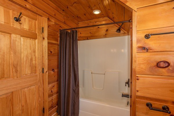 Bathroom with a tub and shower at Mountain Bliss, a 2 bedroom cabin rental located in Pigeon Forge