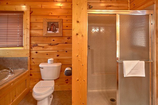 Shower and Jacuzzi in upper floor bathroom at Million Dollar View, a 2 bedroom cabin rental located in Pigeon Forge
