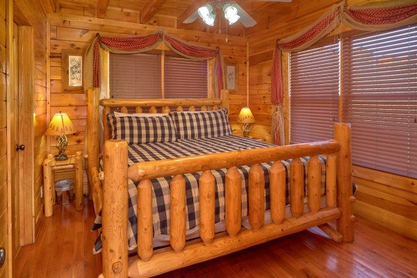 Bedroom on main floor with king bed at Million Dollar View, a 2 bedroom cabin rental located in Pigeon Forge