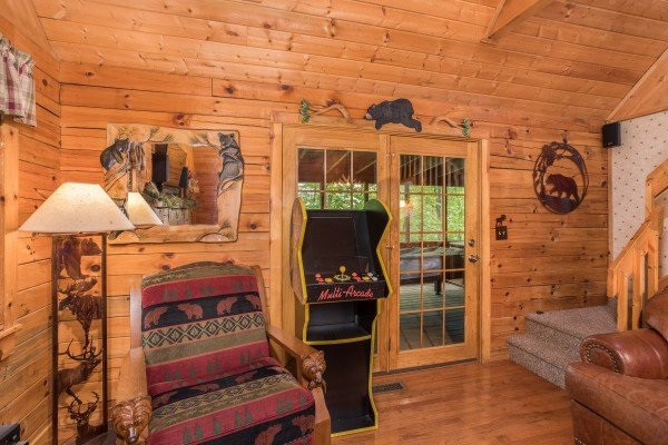 Arcade game in the living room at Whispering Pines, a 2 bedroom cabin rental located in Pigeon Forge