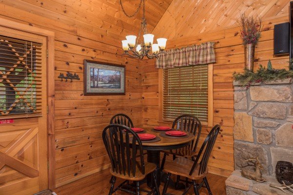 Dining space for four at Whispering Pines, a 2 bedroom cabin rental located in Pigeon Forge