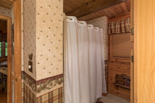 Bathroom with a tub and shower at Whispering Pines, a 2 bedroom cabin rental located in Pigeon Forge