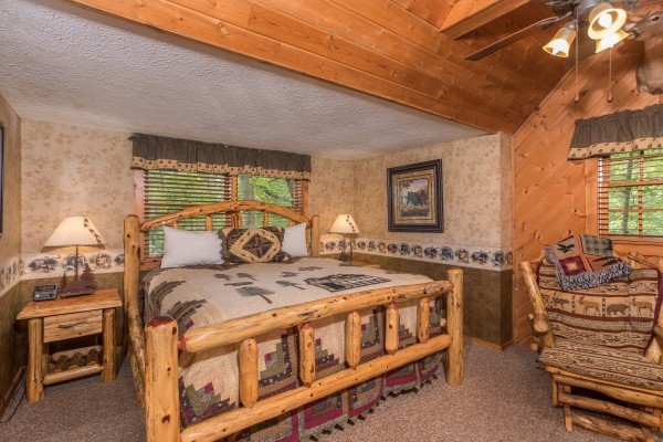 King log bed at Whispering Pines, a 2 bedroom cabin rental located in Pigeon Forge