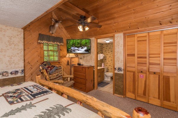 Dresser and TV in the king bedroom with en suite at Whispering Pines, a 2 bedroom cabin rental located in Pigeon Forge