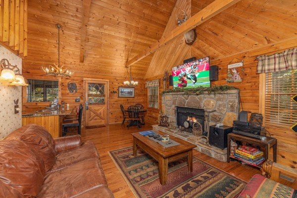 Living room, dining room, and kitchen at Whispering Pines, a 2 bedroom cabin rental located in Pigeon Forge