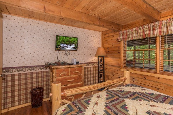 Dresser and TV in a bedroom at Whispering Pines, a 2 bedroom cabin rental located in Pigeon Forge