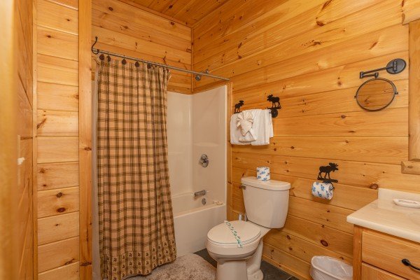 Bathroom with a tub and shower at Smokies Paradise Lodge, a 5 bedroom cabin rental located in Pigeon Forge