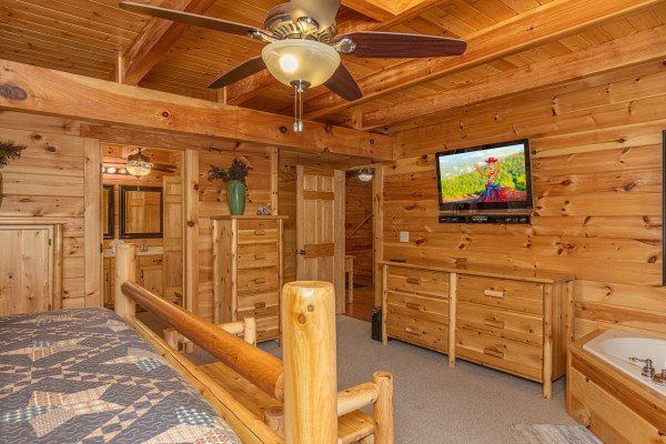 Dresser and TV in a bedroom at Smokies Paradise Lodge, a 5 bedroom cabin rental located in Pigeon Forge