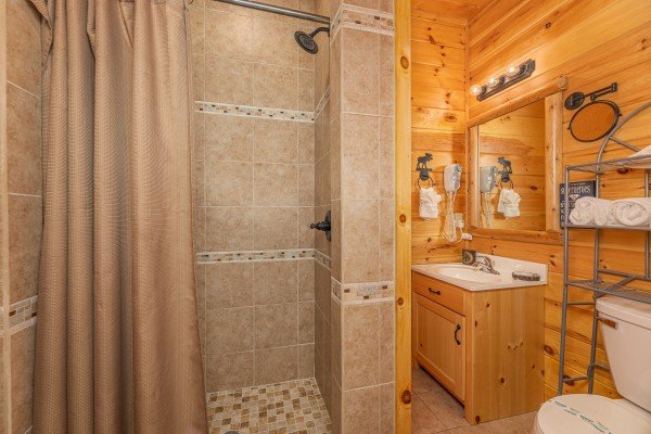 Bathroom with a custom tile shower at Smokies Paradise Lodge, a 5 bedroom cabin rental located in Pigeon Forge