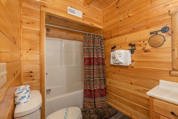 Bathroom with a tub and shower at Smokies Paradise Lodge, a 5 bedroom cabin rental located in Pigeon Forge