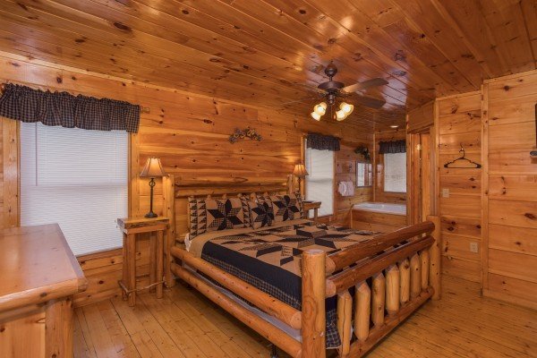 Bedroom with a log bed, night stands, and lamps at Just Relax, a 2 bedroom cabin rental located in Pigeon Forge