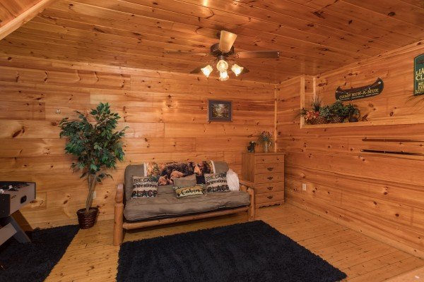 Futon in the game room at Just Relax, a 2 bedroom cabin rental located in Pigeon Forge