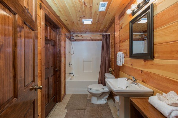 Bathroom with a tub and shower at Tennessee Treasure, a 3 bedroom cabin rental located in Pigeon Forge