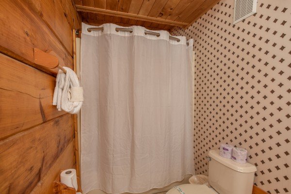 Bathroom with a tub and shower at Sweet Mountain Escape, a 2 bedroom cabin rental located in Pigeon Forge