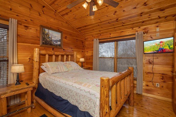 Bedroom with log bed, lamps, night stands, and TV at Dragonfly, a 2 bedroom cabin rental located in Gatlinburg