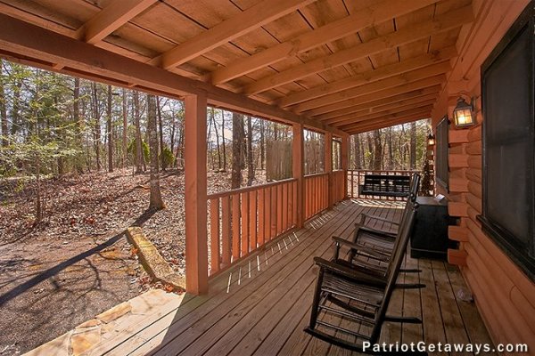 Rocking chairs on a covered deck at Stags Leap, a 2 bedroom cabin rental located in Pigeon Forge