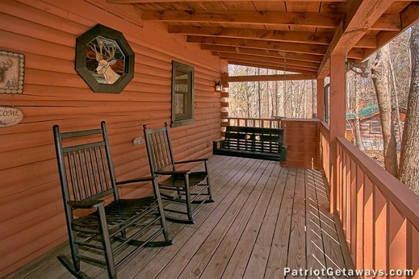 Porch with swing and rocking chairs at Stags Leap, a 2 bedroom cabin rental located in Pigeon Forge