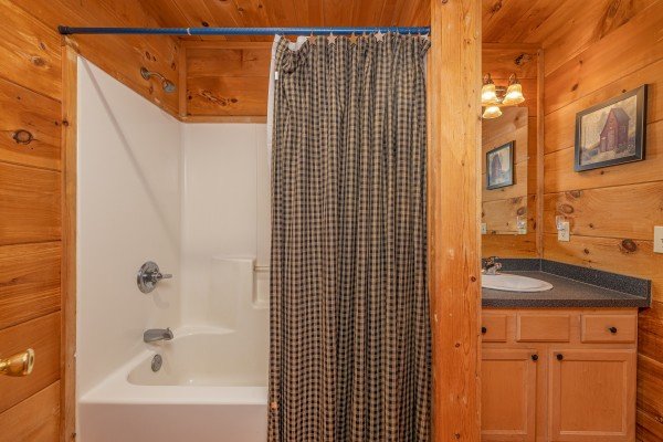Bathroom with a tub and shower at Just You and Me Baby, a 1 bedroom cabin rental located in Gatlinburg