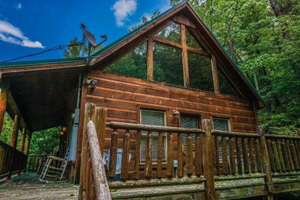 Side view of the front porch and deck at Just You and Me Baby, a 1 bedroom cabin rental located in Gatlinburg