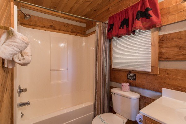 Bathroom with a tub and shower at A Postcard View, a 1 bedroom cabin rental located in Pigeon Forge