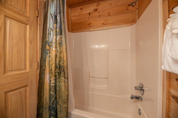 Bathroom with a tub and shower at Southern Comfort Memories, a 2 bedroom cabin rental located in Pigeon Forge