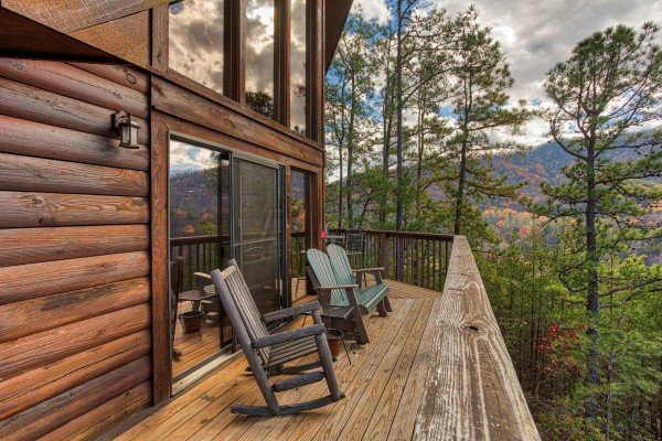 Rocking chairs on the deck with winter views at R & R Hideaway, a 1 bedroom cabin rental located in Pigeon Forge