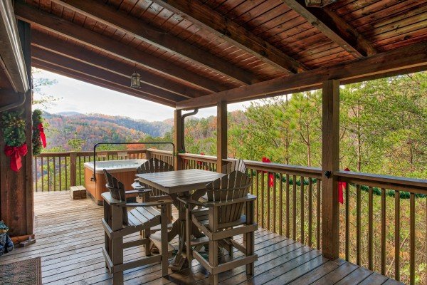 Deck dining for three at R & R Hideaway, a 1 bedroom cabin rental located in Pigeon Forge