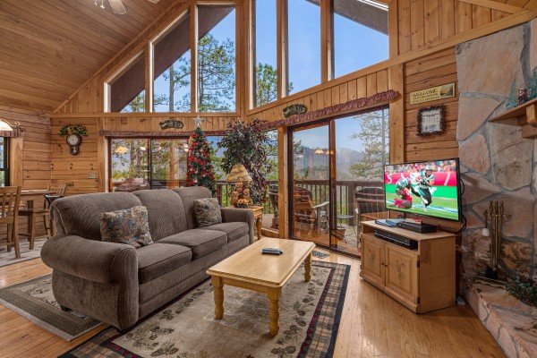 Living room seating and television at R & R Hideaway, a 1 bedroom cabin rental located in Pigeon Forge