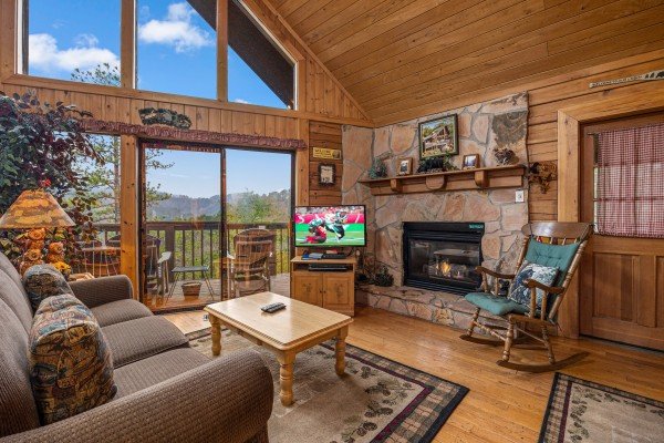 Living room view and fireplace at R & R Hideaway, a 1 bedroom cabin rental located in Pigeon Forge