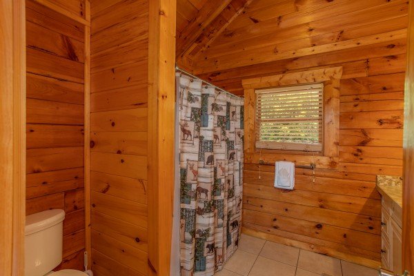 Bathroom with a tub and shower at Majestic Sunrise, a 1 bedroom cabin rental located in Pigeon Forge
