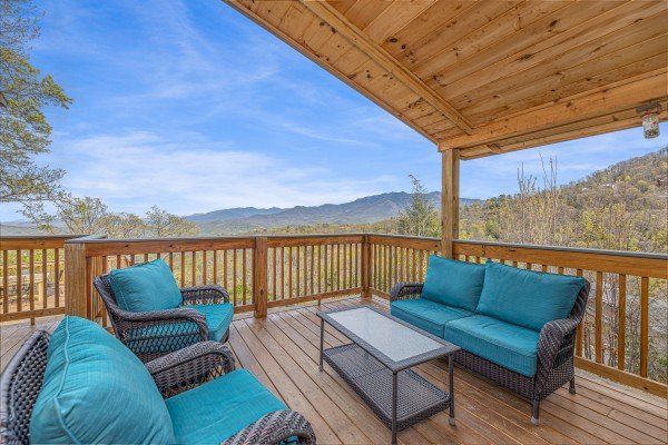 Seating on a covered deck at Ober the Top Views, a 3 bedroom cabin rental located in Gatlinburg