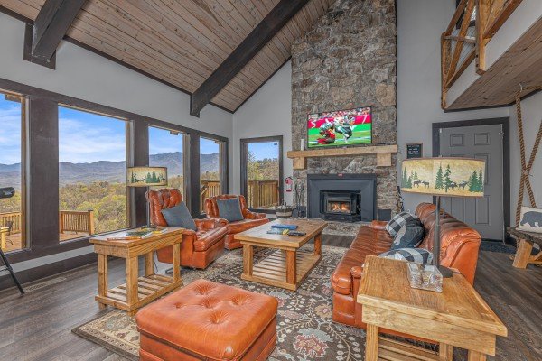 Living room with fireplace, TV, and lots of seating at Ober the Top Views, a 3 bedroom cabin rental located in Gatlinburg