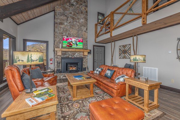 Fireplace and TV in the living room at Ober the Top Views, a 3 bedroom cabin rental located in Gatlinburg