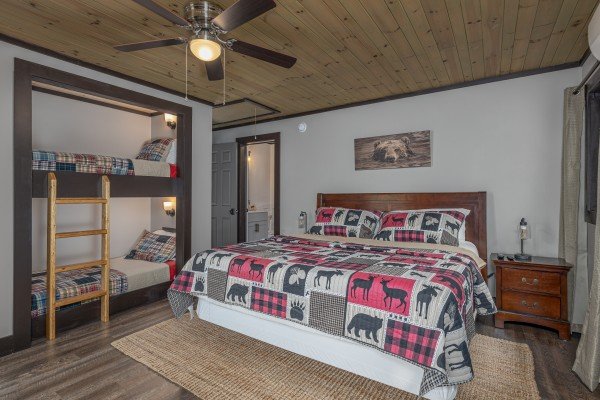 Bedroom with a king bed and two twin bunks at Ober the Top Views, a 3 bedroom cabin rental located in Gatlinburg
