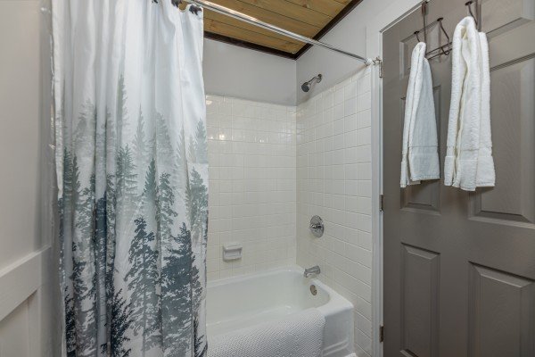 Tub and shower in a bathroom at Ober the Top Views, a 3 bedroom cabin rental located in Gatlinburg