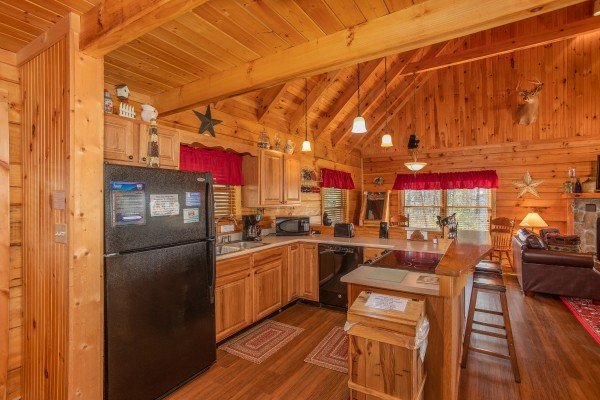 Kitchen with black appliances at Bearfoot Adventure, a 2 bedroom cabin located in Gatlinburg