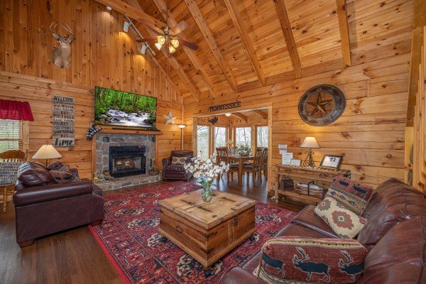 Living room with fireplace and seating at Bearfoot Adventure, a Gatlinburg Cabin rental