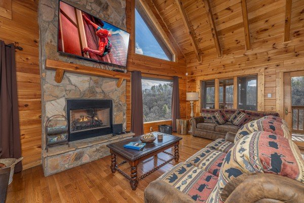 TV, fireplace, and views from the living room at Mountain Mama, a 3 bedroom cabin rental located in Pigeon Forge