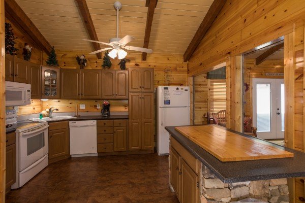 Kitchen with white appliances at Rustic Ranch, a 2 bedroom cabin rental located in Pigeon Forge