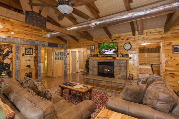 Living room with fireplace and TV at Rustic Ranch, a 2 bedroom cabin rental located in Pigeon Forge