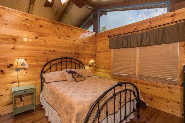 Bedroom with a queen bed, night stands, and lamps at Rustic Ranch, a 2 bedroom cabin rental located in Pigeon Forge