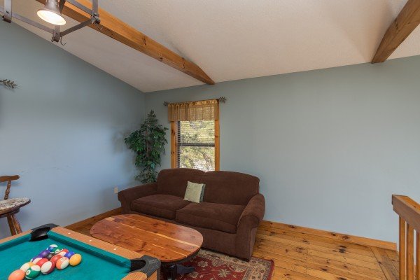 Loveseat in the loft at Alone at the Top, a 3 bedroom cabin rental located in Pigeon Forge