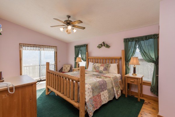 Bedroom with a log bed, night tables, and lamps at Alone at the Top, a 3 bedroom cabin rental located in Pigeon Forge