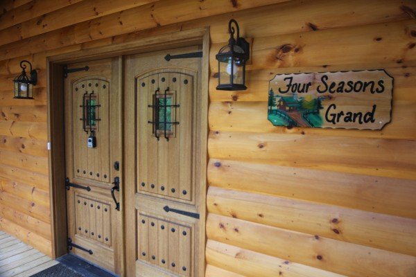 Front door cabin sign at Four Seasons Grand, a 5 bedroom cabin rental located in Pigeon Forge